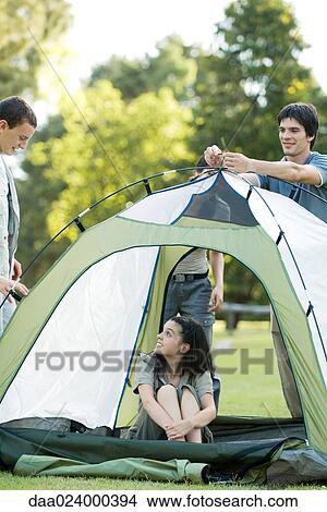 Picture - Young campers setting up tent. Fotosearch