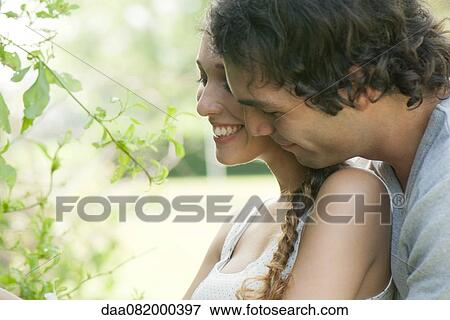 Stock Photo - Young couple embracing outdoors. Fotosearch