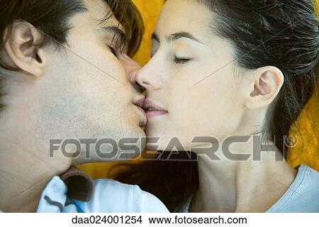 Picture - Young couple kissing, close-up. Fotosearch