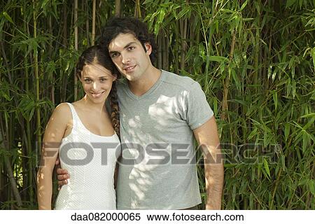 Young couple together outdoors, portrait View Large Photo Image Stock Photography - Young couple together outdoors, portrait. Fotosearch