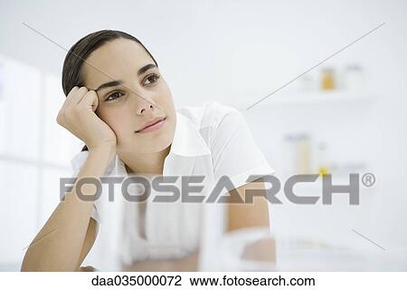 Young female leaning on elbow and looking away View Large Photo Image Stock Image - Young female leaning on elbow and looking away. Fotosearch