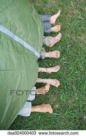Young friends in tent, feet sticking out, high angle view View Large Photo Image Stock Image - Young friends in tent, feet sticking out, high angle view. Fotosearch