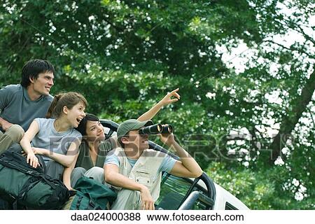 Young hikers in back of pick-up truck, looking at something out of frame View Large Photo Image Stock Photo - Young hikers in back of pick-up truck, looking at something out of frame. Fotosearch