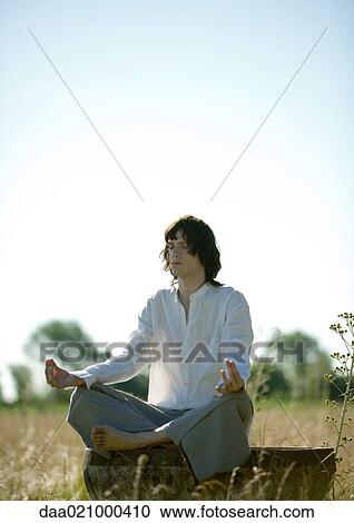 Young male doing yoga in field View Large Photo Image Stock Image - Young male doing yoga in field. Fotosearch
