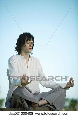 Young male meditator, eyes closed View Large Photo Image Stock Photo - Young male meditator, eyes closed. Fotosearch