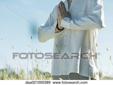 Young male meditator, hands clasped, cropped view of mid section View Large Photo Image Stock Photo - Young male meditator, hands clasped, cropped view of mid section. Fotosearch