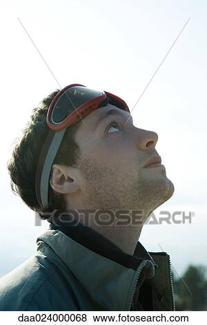 Young man dressed in winter clothing, looking up View Large Photo Image Stock Photo - Young man dressed in winter clothing, looking up. Fotosearch