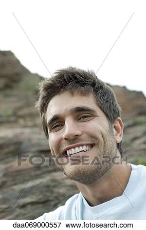 Young man laughing outdoors, portrait View Large Photo Image Stock Photo - Young man laughing outdoors, portrait. Fotosearch