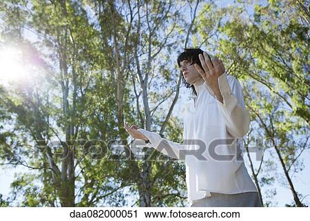 Young man meditating outdoors View Large Photo Image Stock Image - Young man meditating outdoors. Fotosearch