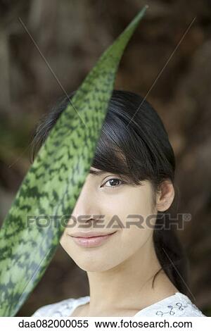 Young woman behind snake plant leaf View Large Photo Image Stock Photography - Young woman behind snake plant leaf. Fotosearch