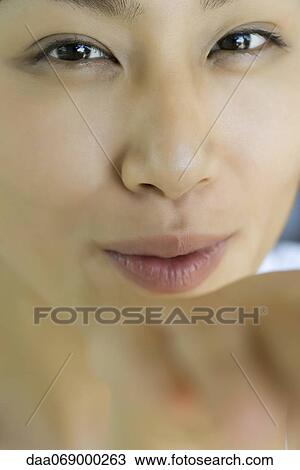 Young woman blowing a kiss at camera View Large Photo Image Stock Image - Young woman blowing a kiss at camera. Fotosearch