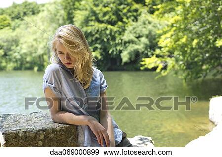 Stock Photo - Young woman by lake. Fotosearch
