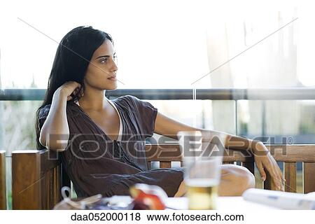 Young woman contemplatively looking away View Large Photo Image Stock Photo - Young woman contemplatively looking away. Fotosearch