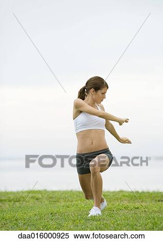 Young woman doing stretching exercises by lakeside View Large Photo Image Stock Photography - Young woman doing stretching exercises by lakeside. Fotosearch