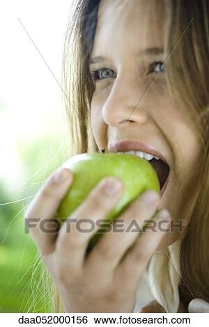 Young woman eating green apple View Large Photo Image Stock Photograph - Young woman eating green apple. Fotosearch