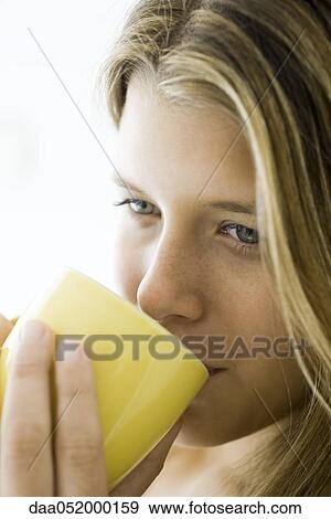 Young woman enjoying cup of coffee, portrait View Large Photo Image Stock Photo - Young woman enjoying cup of coffee, portrait. Fotosearch