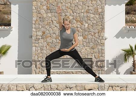 Young woman exercising outdoors View Large Photo Image Stock Photo - Young woman exercising outdoors. Fotosearch