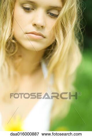 Young woman, eyes lowered, portrait View Large Photo Image Stock Photo - Young woman, eyes lowered, portrait. Fotosearch