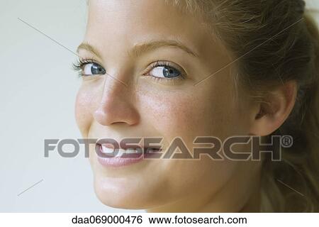 Young woman glancing sideways at camera, portrait View Large Photo Image Stock Photograph - Young woman glancing sideways at camera, portrait. Fotosearch