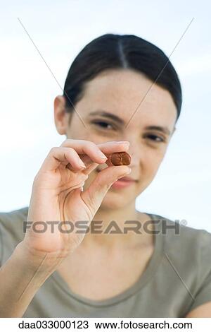 Young woman holding broad bean between her fingers, showing it to camera View Large Photo Image Stock Image - Young woman holding broad bean between her fingers, showing it to camera. Fotosearch