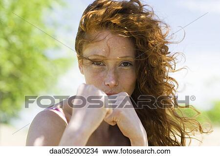 Young woman holding clenched fists toward camera View Large Photo Image Picture - Young woman holding clenched fists toward camera. Fotosearch