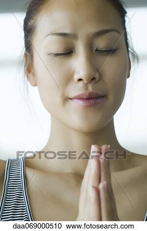 Young woman holding hands in prayer position View Large Photo Image Stock Image - Young woman holding hands in prayer position. Fotosearch