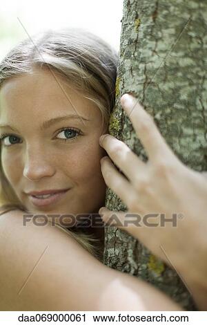 Young woman hugging tree, portrait View Large Photo Image Stock Image - Young woman hugging tree, portrait. Fotosearch