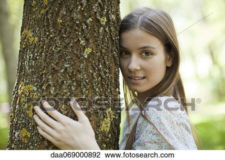 Young woman hugging tree, portrait View Large Photo Image Stock Image - Young woman hugging tree, portrait. Fotosearch
