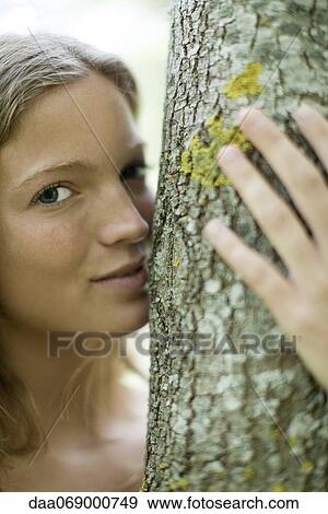 Young woman hugging tree, portrait View Large Photo Image Stock Photo - Young woman hugging tree, portrait. Fotosearch
