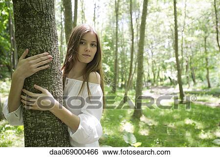 Young woman hugging tree, portrait View Large Photo Image Stock Photograph - Young woman hugging tree, portrait. Fotosearch