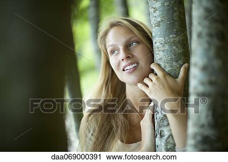 Young woman hugging tree View Large Photo Image Stock Image - Young woman hugging tree. Fotosearch