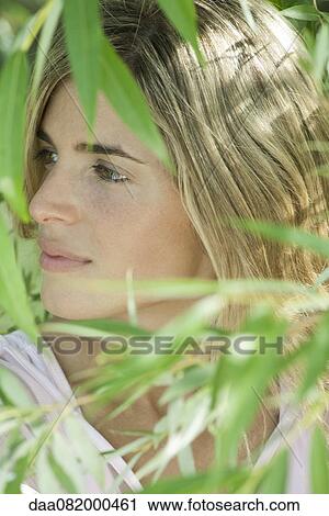Stock Image - Young woman in bamboo grove. Fotosearch