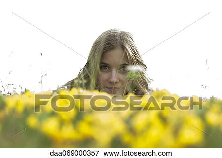 Young woman in flower field View Large Photo Image Stock Photo - Young woman in flower field. Fotosearch