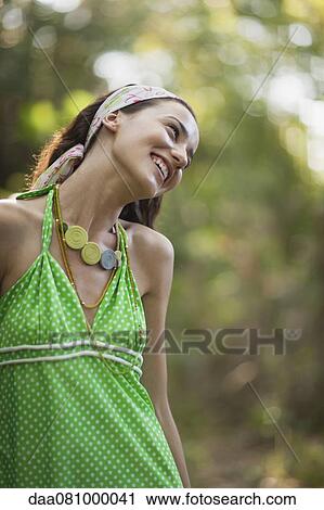 Young woman in halter top outdoors, smiling View Large Photo Image Stock Image - Young woman in halter top outdoors, smiling. Fotosearch