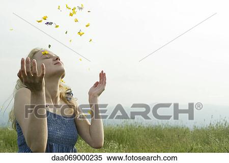 Young woman in meadow, covered in wildflowers View Large Photo Image Stock Photography - Young woman in meadow, covered in wildflowers. Fotosearch
