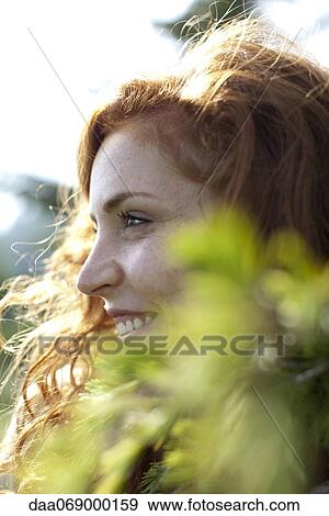 Stock Photo - Young woman in nature, cropped. Fotosearch