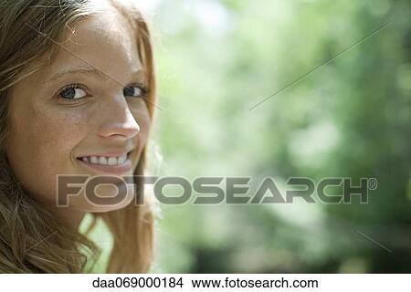 Picture - Young woman in nature, portrait. Fotosearch