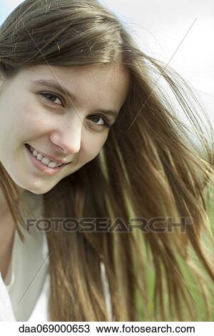 Stock Image - Young woman in nature, portrait. Fotosearch