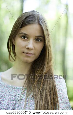 Stock Image - Young woman in nature, portrait. Fotosearch