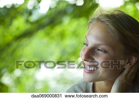 Stock Image - Young woman in nature, portrait. Fotosearch