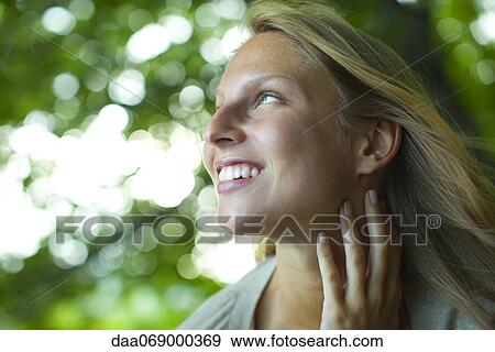 Stock Photo - Young woman in nature, portrait. Fotosearch