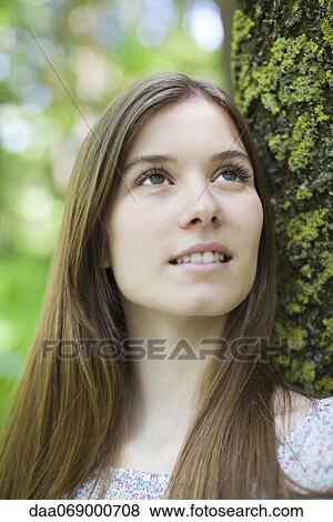 Stock Photo - Young woman in nature, portrait. Fotosearch