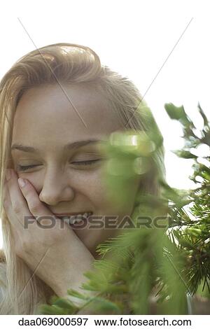 Young woman in nature, smiling with eyes closed View Large Photo Image Stock Photo - Young woman in nature, smiling with eyes closed. Fotosearch