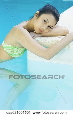 Young woman in pool, resting head on edge of pool View Large Photo Image Stock Image - Young woman in pool, resting head on edge of pool. Fotosearch
