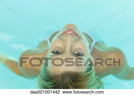 Young woman in pool, smiling at camera, view from directly above View Large Photo Image Stock Image - Young woman in pool, smiling at camera, view from directly above. Fotosearch