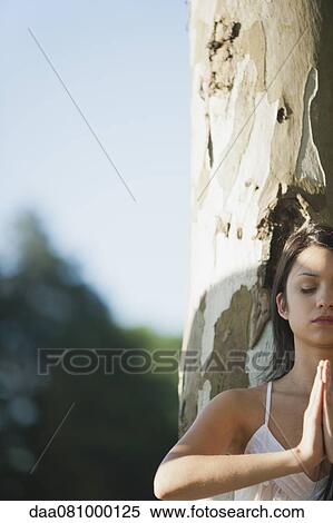Stock Photography - Young woman in prayer position, cropped. Fotosearch