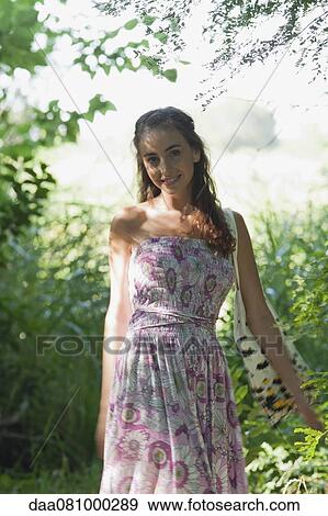 Young woman in woods, portrait View Large Photo Image Stock Photo - Young woman in woods, portrait. Fotosearch