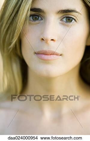 Young woman looking at camera, cropped portrait, close-up View Large Photo Image Picture - Young woman looking at camera, cropped portrait, close-up. Fotosearch