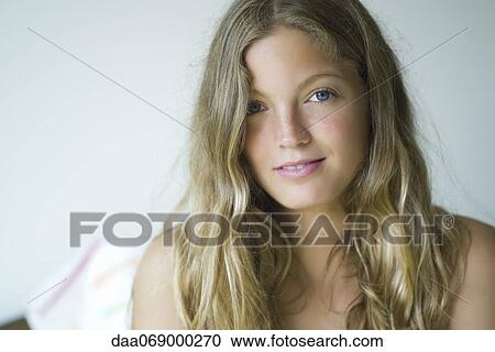 Young woman looking at camera, portrait View Large Photo Image Stock Image - Young woman looking at camera, portrait. Fotosearch