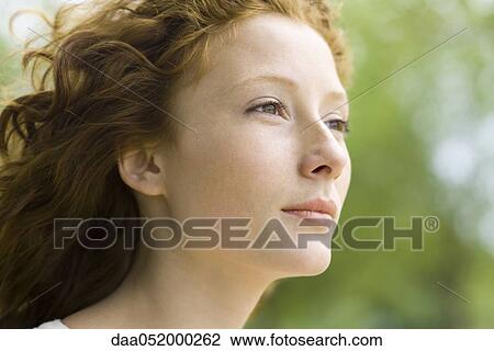 Young woman looking away in thought, portrait View Large Photo Image Stock Image - Young woman looking away in thought, portrait. Fotosearch